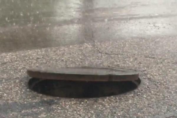 Air-pressure-causes-manhole-cover-to-float-in-Phoenix-road