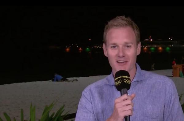 Couple-reading-a-book-on-beach-interrupt-Olympics-broadcast